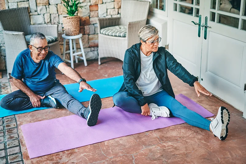 elderly man and woman stretching 
