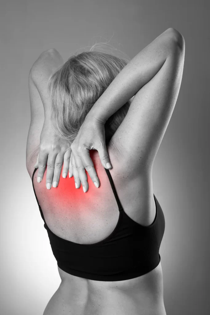 a woman suffering from upper back pain